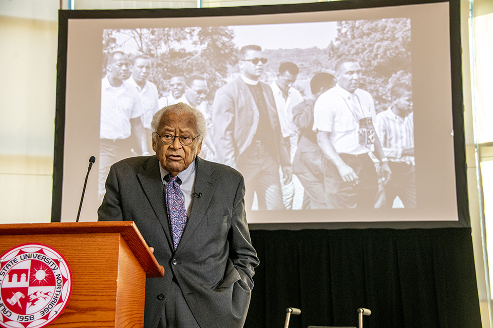 Reverend James Lawson stands in front of projected image during his lecture on non-violence.