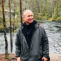 CSUN student and music education entrepreneur Richard Frank stands by a stream in Helsinki.