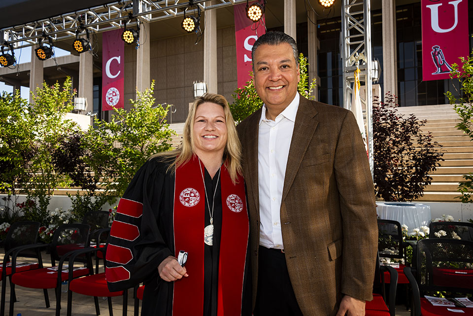 President Erika D. Beck stands next to U.S. Senator Alex Padilla, on stage after the Commencement ceremony for CSUN's College of Social and Behaviorial Sciences.