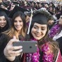 Students take selfie at commencement.