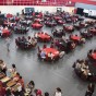 CSUN faculty, staff and their families sit down in the decorated Red Ring Courts area and enjoy food, music and festivities.