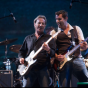 Bill Worrell (right) and Dewey Bunnell (left) playing guitar next to each other.