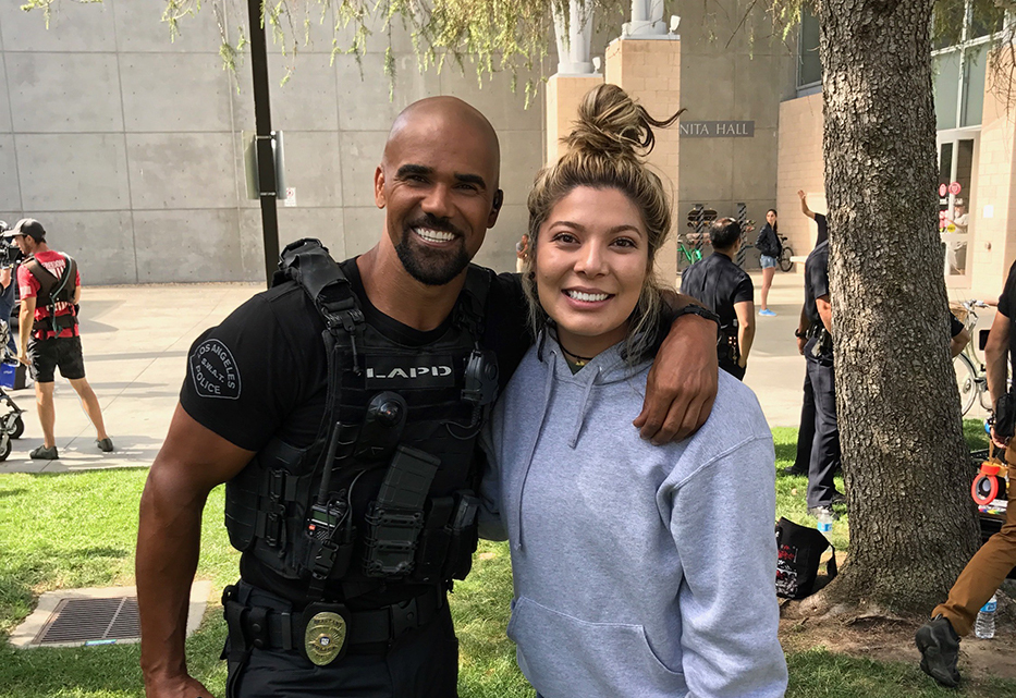 Actor Shemar Moore of the show "S.W.A.T." poses with junior biology major Marisol Castorena during a break from filming on the California State University, Northridge campus. 