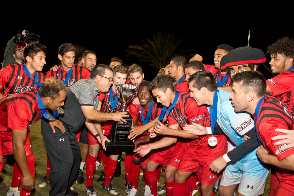 CSUN Men's soccer team lifts Big West championship cup.