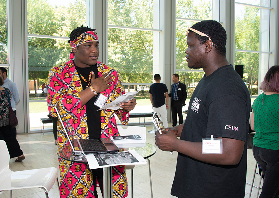 Student Devon Williams (left) talks about his Africana Studies project, 