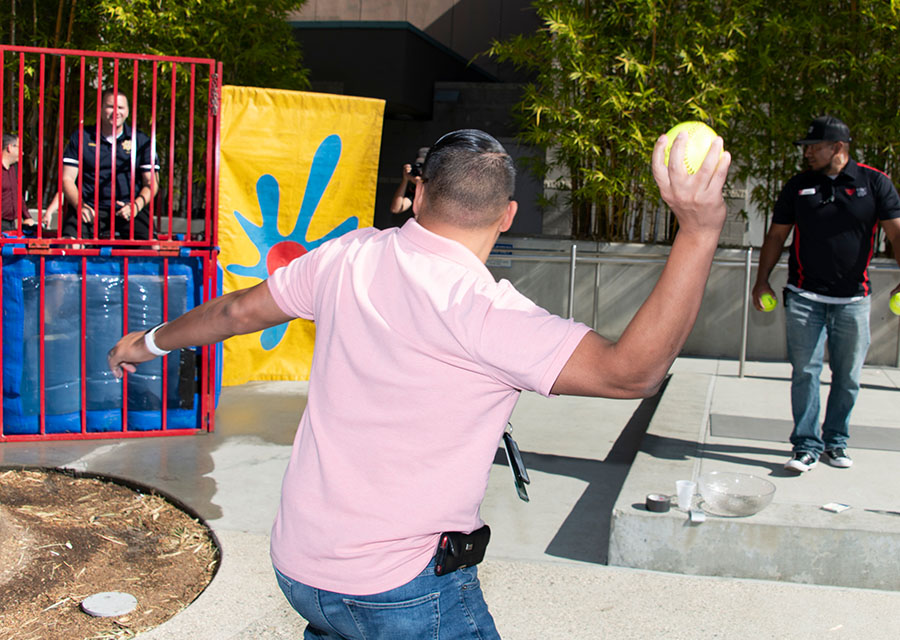 An attendee preparing to take a shot at the dunk tank.