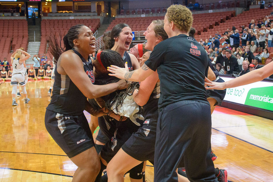 CSUN players embrace after victory.