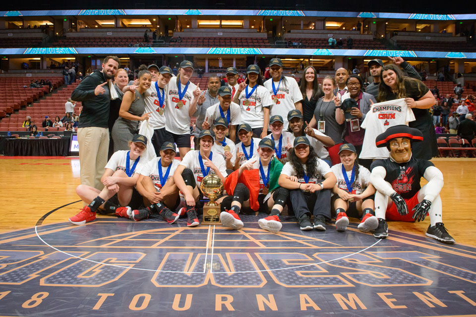 Group photo of CSUN women's basketball team after winning Big West championship.