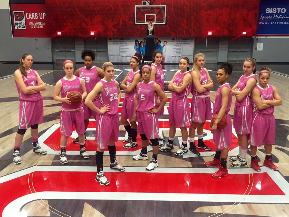 CSUN women's basketball team wearing pink jerseys.