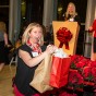 National Center on Deafness interpreter Kathryn Bess celebrates as she picks up a prize from the Winter Celebration raffle.