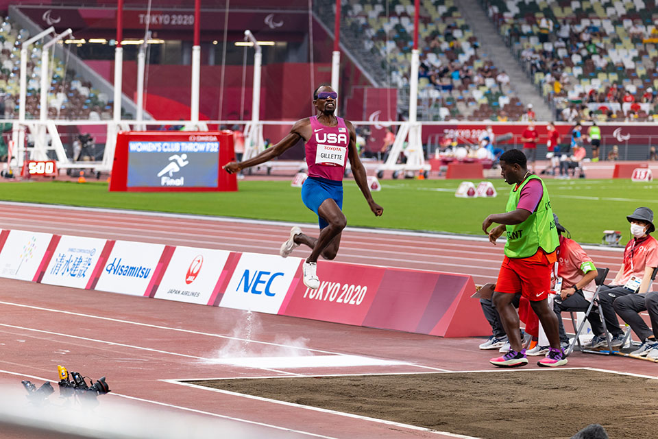 Gillette long jumps with Williams guiding him at the 2020 Paralympic Games in Tokyo. (Olympic Information Services)