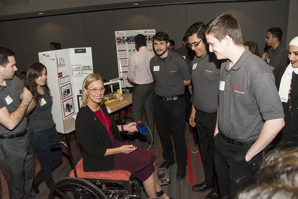 Students display Wheelchair Assist project to CSUN President.