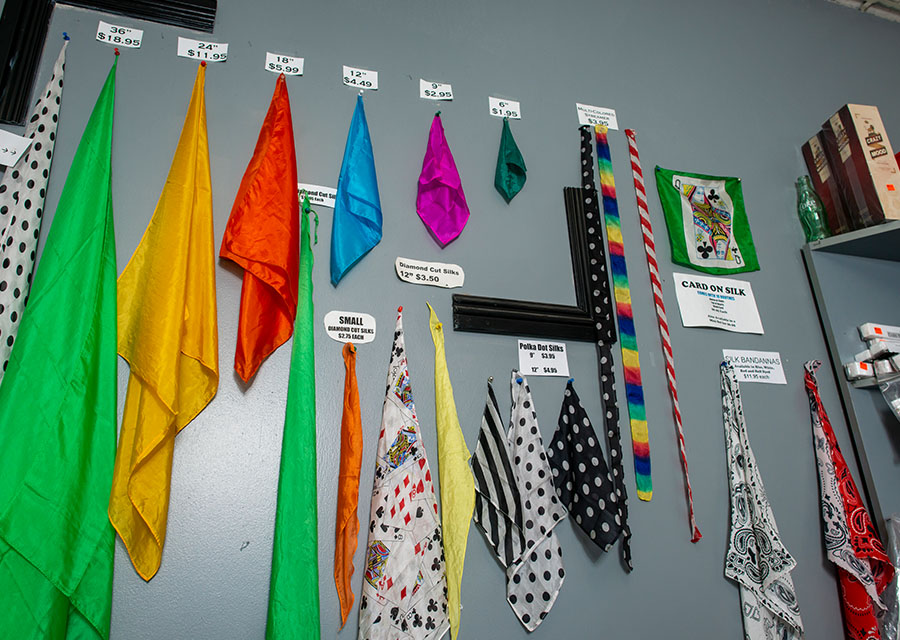 Geris' wall of handkerchiefs. The handkerchiefs are arranged in various sizes and lengths, some on one solid color, such as yellow, blue and red, and some have striped or polkadot patterns.