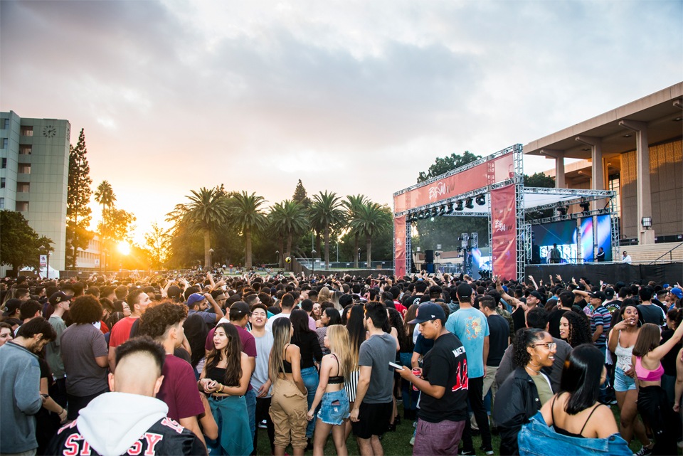 Crowd in front of Big Show stage at sun sets over CSUN's palms.