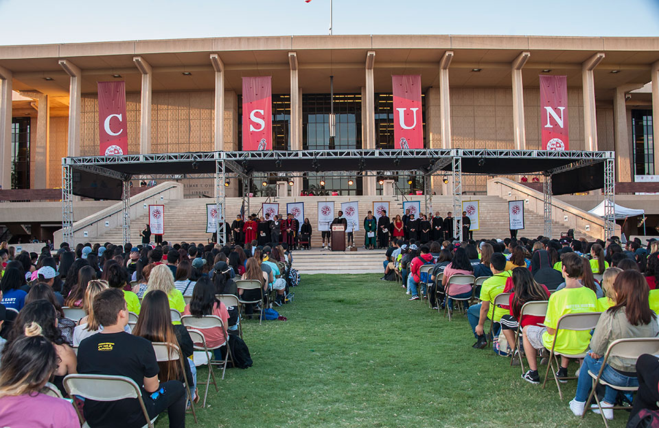 CSUN administration officials greet freshmen in front of the Oviatt Library.