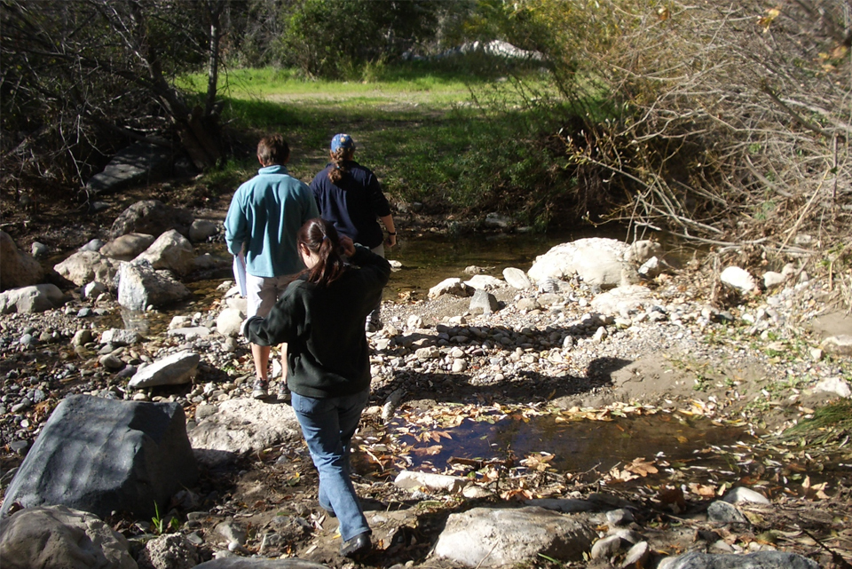 Students cross a creek in Topanga Canyon.