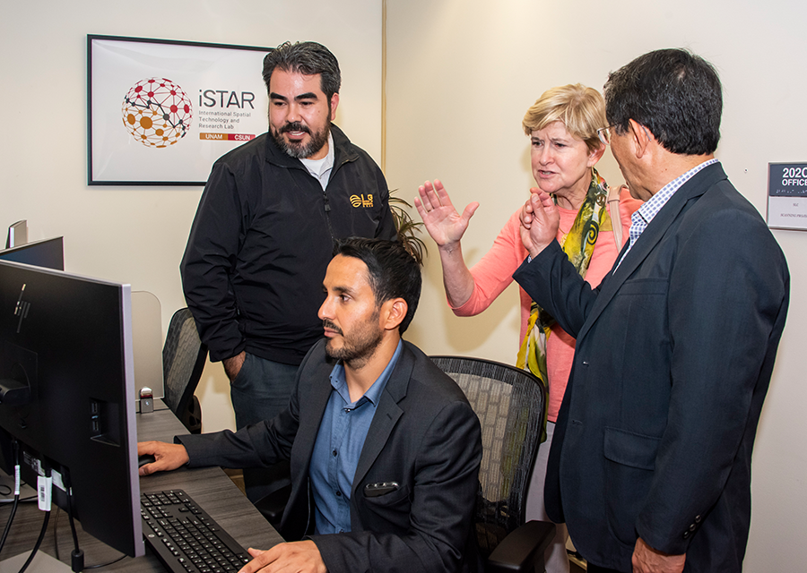 Héctor Daniel Reséndiz López, Rodrigo Jiménez Del Valle, Mary Beth Walker and Alberto Ken Oyama Nakagawa look into one of the new workstations at the iSTAR Lab.