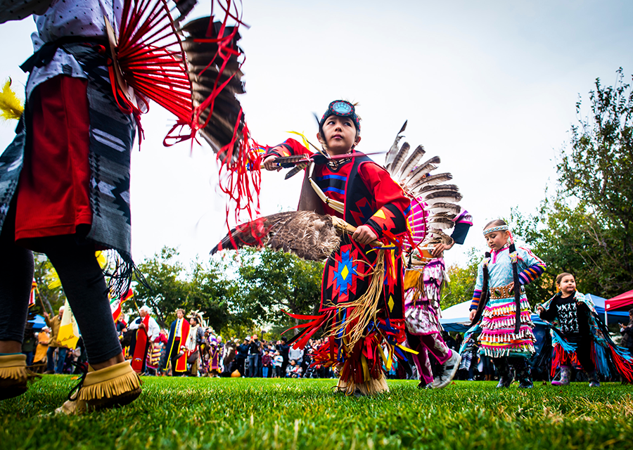 A child dances in American Indian regalia at the 2019 CSUN Powwow.