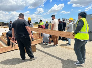 A group of senior mechanical engineering students on site as they begin building a frame for one of the three modules needed to complete their structure. Photo by Kaley Block