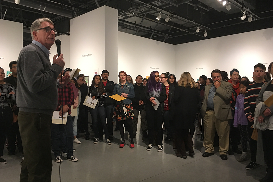 Retiring CSUN Art Galleries director Jim Sweeters talks to students during a High School Invitational event at the Main Gallery. 