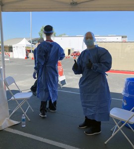 Loren Fung and Eric Blum in full protective gear at the El Monte drive-through COVID-19 testing site.
