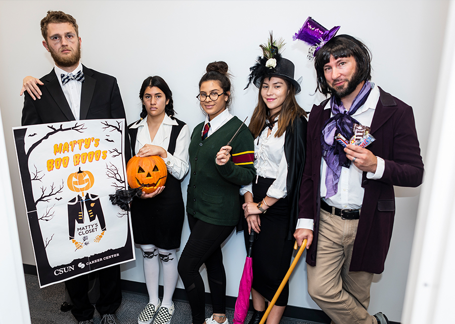 Ryan Silber, Michelle Hernandez, Karen Acevedo, Andrea Escobar and Daniel Levitch stand in a row in their costumes. Silber is holding a poster for Matty's Boo Boos.