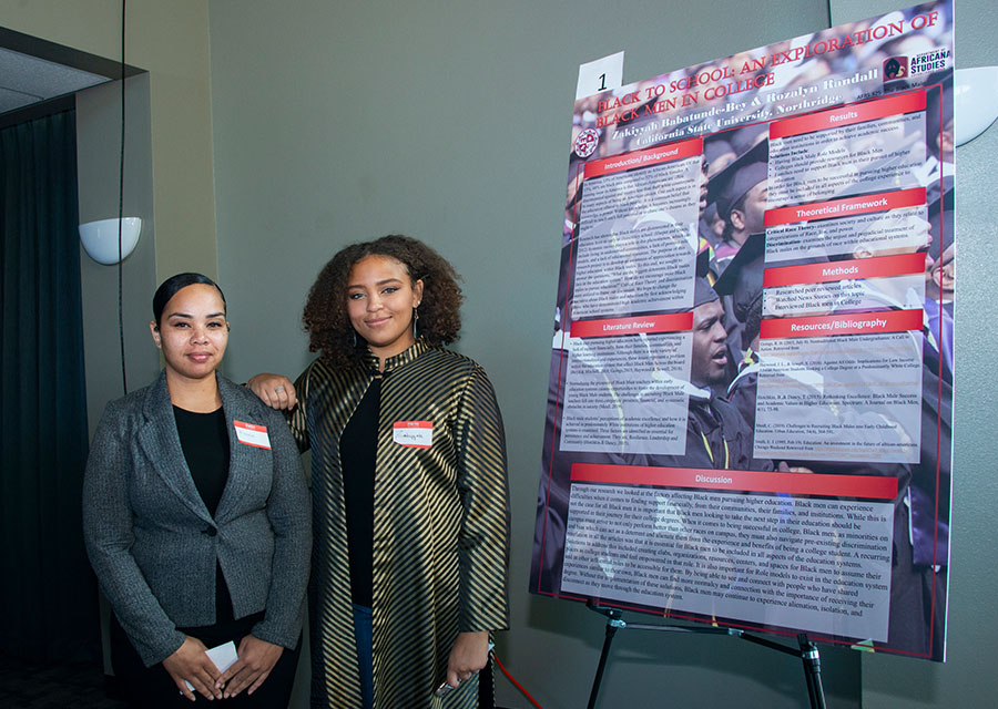 Zakiyyah Babatunde-Bey and Rozalyn Randall stand by their poster