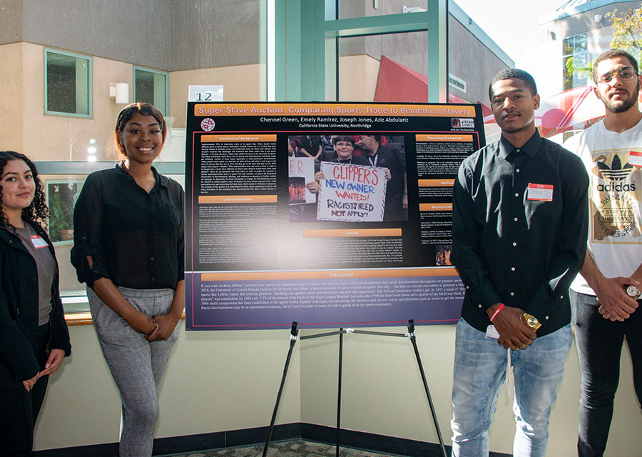 Anis Abduaziz, Chanell Green Joseph Jones and Emily Ramirez stand by their poster