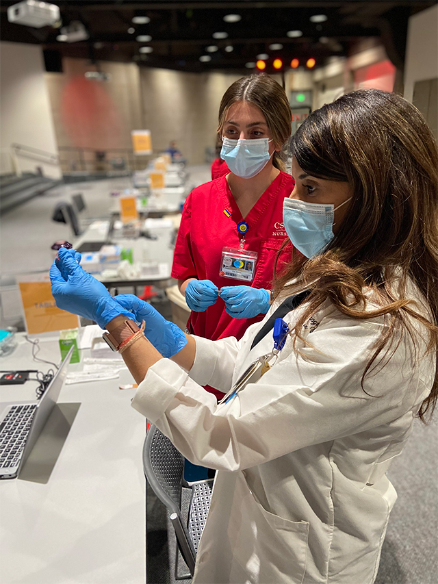 CSUN nursing student Nina Amirian watches Gina Rai, Valley Presbyterian Hospital's clinical nurse manager, Children's Services, on a shift to deliver COVID-19 vaccines to hospital employees. Photo courtesy of Nina Amirian.