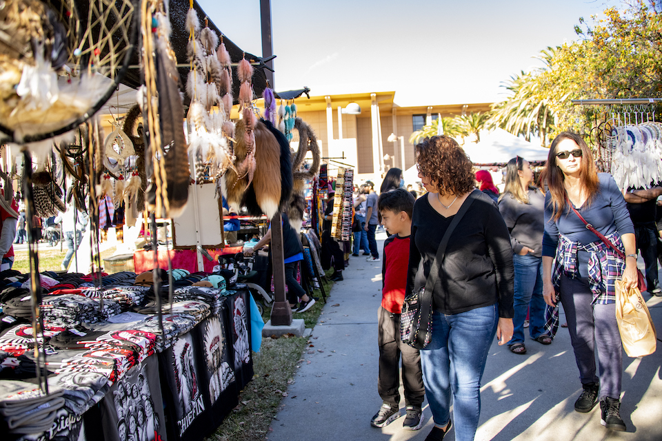 People stroll along long line of craft booths at the CSUN Powwow.