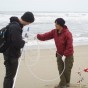 Priya Ganguli and a student collect water samples on the California coast.