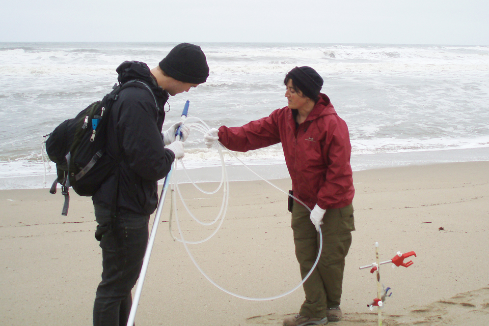 Priya Ganguli and a student collect water samples on the California coast.