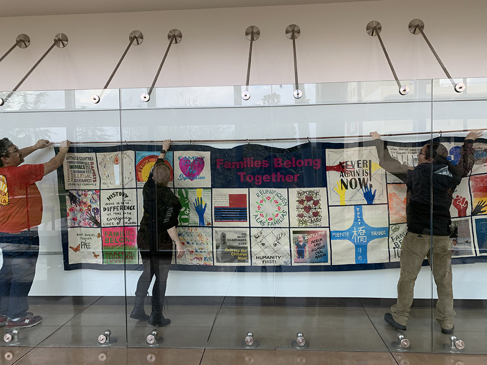 A quilt for "Tsuru for Solidarity" being put up earlier this year in Manzanita Hall by CSUN alumnus and member of Tsuru for Solidarity member Tony Osumi (left), CSUN student Elayna Bisby (center) and Asian American studies professor Clement Lai (right). Lai, a member of CSUN;s Civil Discourse and Social Change, which has received a $100,000 grant from the California Civil Liberties Public Education Fund to draw on lessons learned from the incarceration of Japanese Americans during World War II to improve the lives of Asian Americans today. Photo courtesy of Jinah Kim.