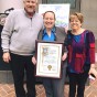 Pride Center's Sarina Loeb standing next Sarina Loeb with her parents, mother Abby Loeb and my step-dad Dr. Bruce Figoten.at her recognition in May 2018 at the City Hall.
