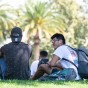 Two students sit on the lawn and talk at CSUN.