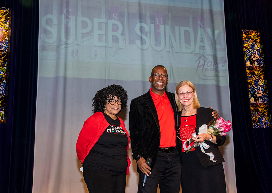 Gigi McGuire, CSUN assistant director of community and academic partnerships; Charles Humphrey, pastor of H.O.P.E.’s House Christian Ministries; and CSUN President Dianne F. Harrison., on stage at the church.