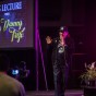 Actor Danny Trejo walks out on stage in the Northridge Center, waving.