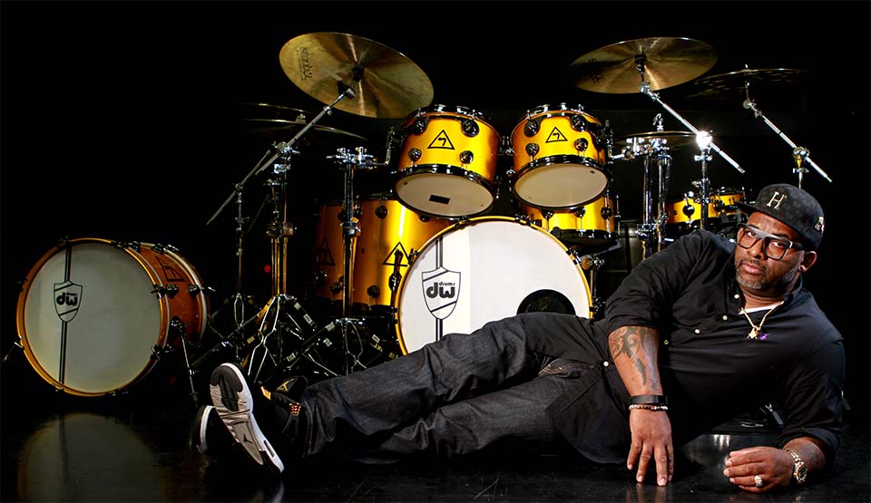 Trevor Lawrence, Jr. lies in front of drum set