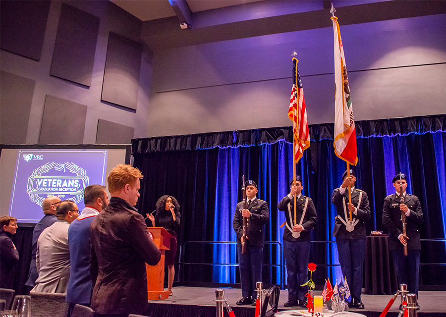 CSUN's graduating student veterans stand together to sing the national anthem during the Veterans Graduation Reception 2019 on May 16 at the Northridge Center.