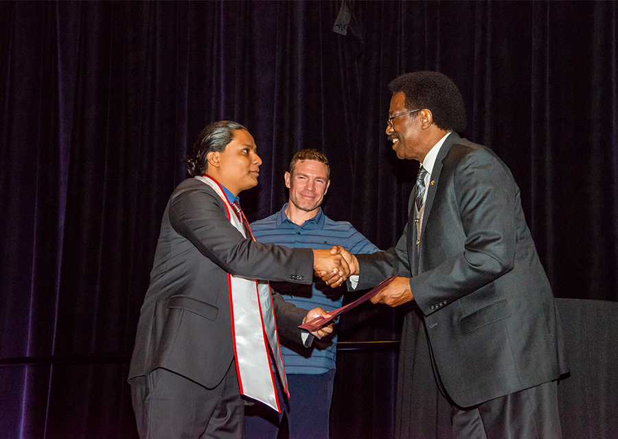 CSUN Vice President for Student Affairs and Dean of Students William Watkins presents a student veteran with his award at the Veterans Graduation Reception 2019, held on May 16 at the Northridge Center.
