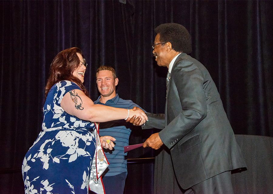 CSUN Vice President for Student Affairs and Dean of Students William Watkins presents a student veteran with her award at the Veterans Graduation Reception 2019, held on May 16 at the Northridge Center.